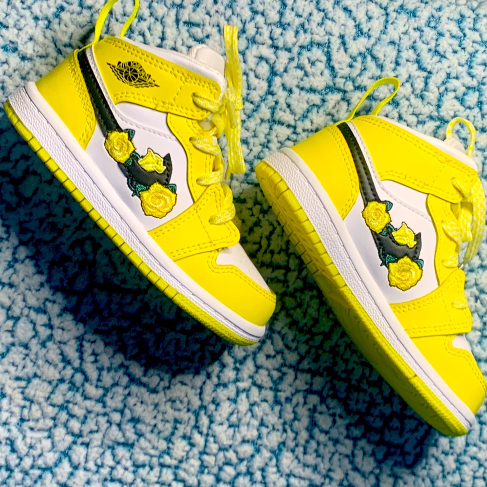 Yellow /black floral Nike in size 7c. My baby wore them once. Like new